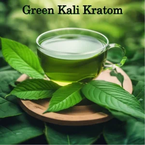 A cup of Green Kali Kratom tea with kratom leaves surrounding the cup